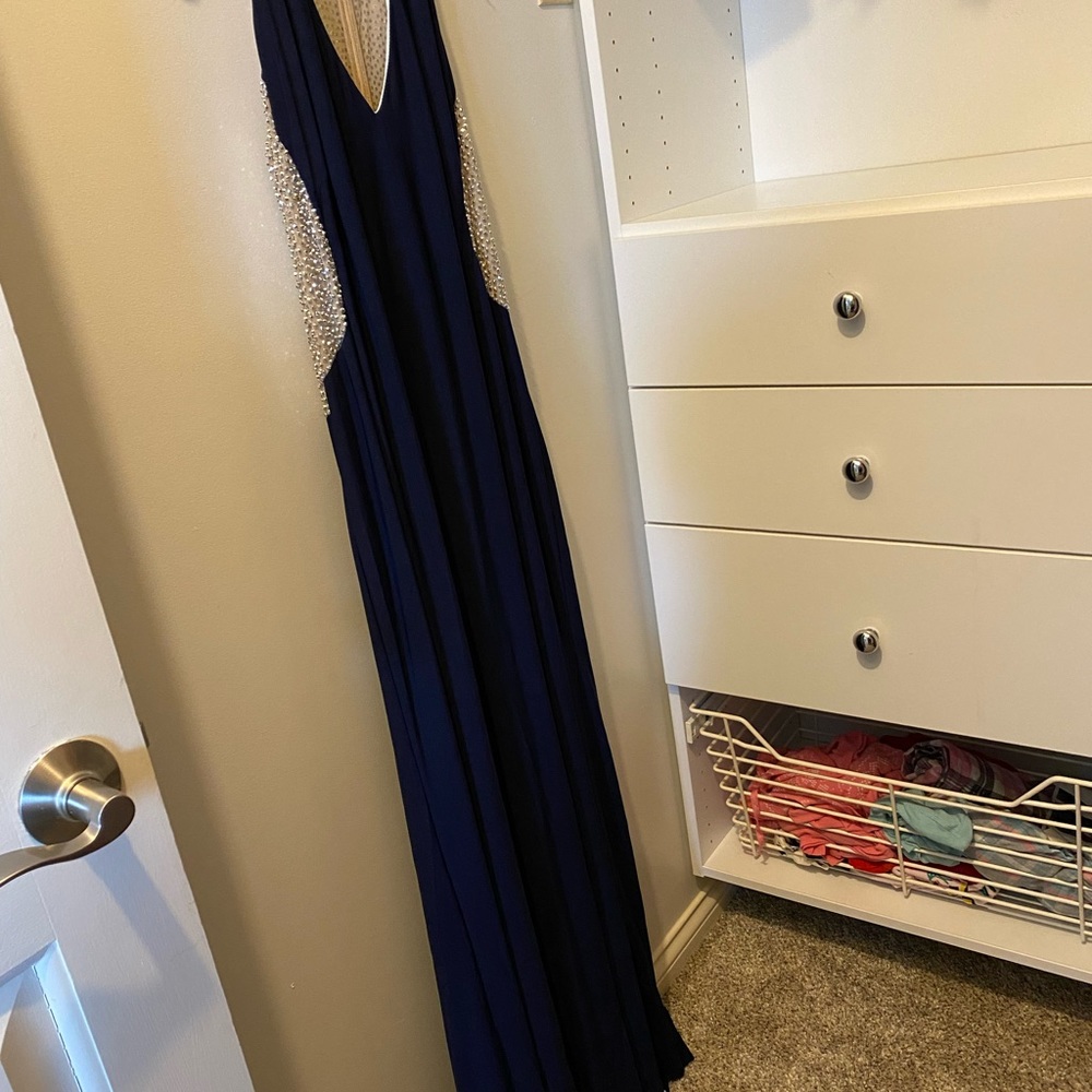 Xscape navy blue dress with slimming beaded accents on sides and slit in front.